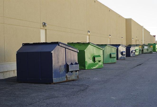 construction workers loading debris into dumpsters on a worksite in Hume, VA